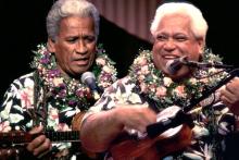 Two men on a stage paling instruments.