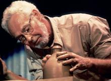 A man shaping a ceramic vase.