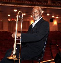 A man hiolding a trombone.