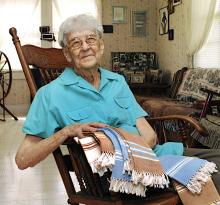 A woman on a reclining chair showing weavins.