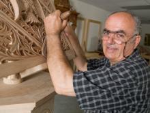 A man making a wood carving.