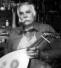 A man holding a string oinstrumant.