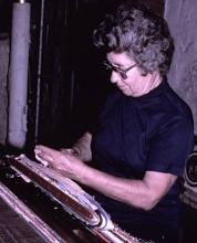 a woman weaving.