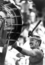 A man playing a big drum.