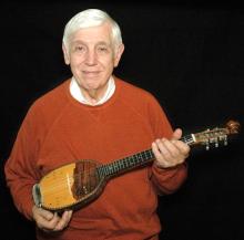 Man holding a mandolin.