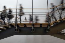 soft-focus photo of people using a metal stairway