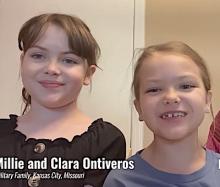 Two young female children up close speaking to the camera