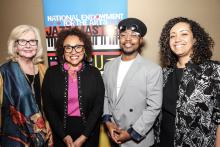 photo of three women and one man standing in front of NEA Jazz Masters signage