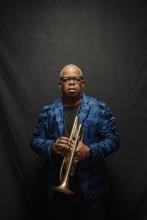 Photo of a Black man holding a trumpet