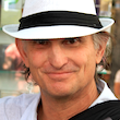 Headshot of a man with a hat.