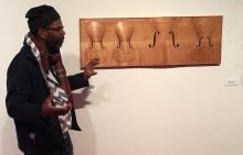 paul_rucker_explains_wood_carvings_during_art_studio_tour