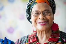 headshot of Linda Goss wearing a colorful headwrap and beaded jewelry
