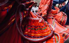 close-up of Latinx dancers in colorful skirts