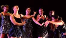 a group of women of color dancing