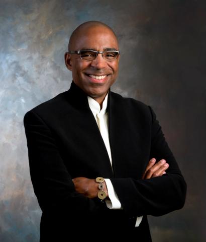 Smiling African-American man standing with arms crossed