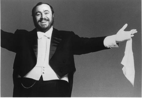 Man with beard in a tuxedo holding a handkerchief in his left hand