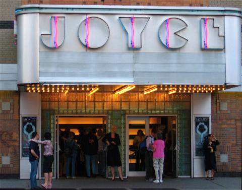 The front of the Joyce Theater with a people waiting in line to get in. 