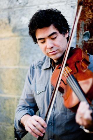 Portrait of Japanese American man playing a violin. 