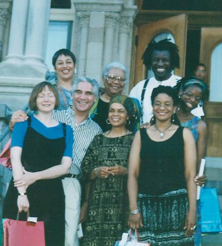 Group of Black writers standing in front of a building.
