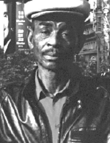 Black and white photo of a man wearing a hat
