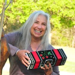 Woman laughing holding beaded box.