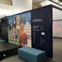 a large class room with colorful murals painted on the outside walls