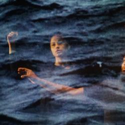 two people seen through a blue scrim