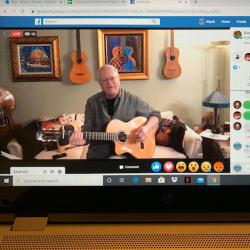screen shot of an older man holding a ukulele