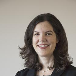 Portrait of dark-haired woman in suit. 