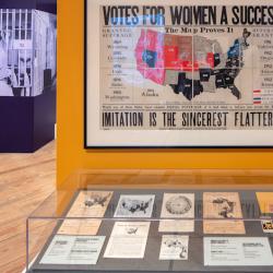 a photograph of an antique map shows the progress in the women's suffrage movement