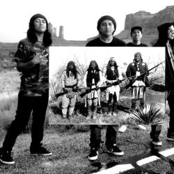 a group of young Native men holding an enlarged photo of a group of older Native people