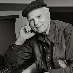 Portrait of Bob McQuillen sitting at the piano