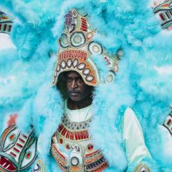A man in a featherede costume.