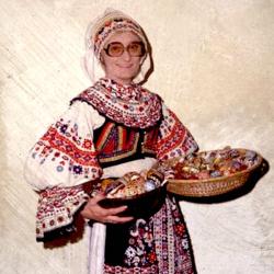A woman in traditional dress holding a basket.