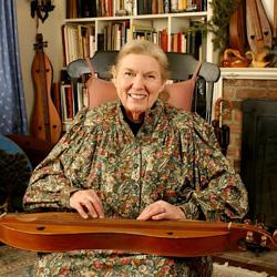 A woman with a dulcimer on her lap.
