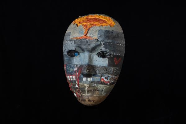 Defend and Protect by Chris Harris An intricately painted mask in mostly shades of grey with words of inspiration and hope