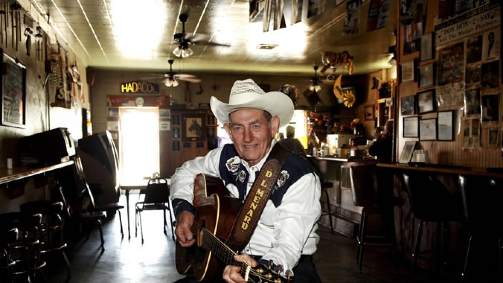 Country singer with guitar sitting