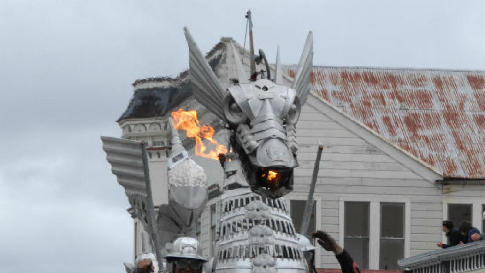 a dragon bicycle sculpture parades down a town's main street