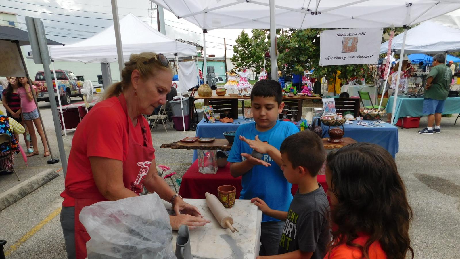 children at art fair play with clay