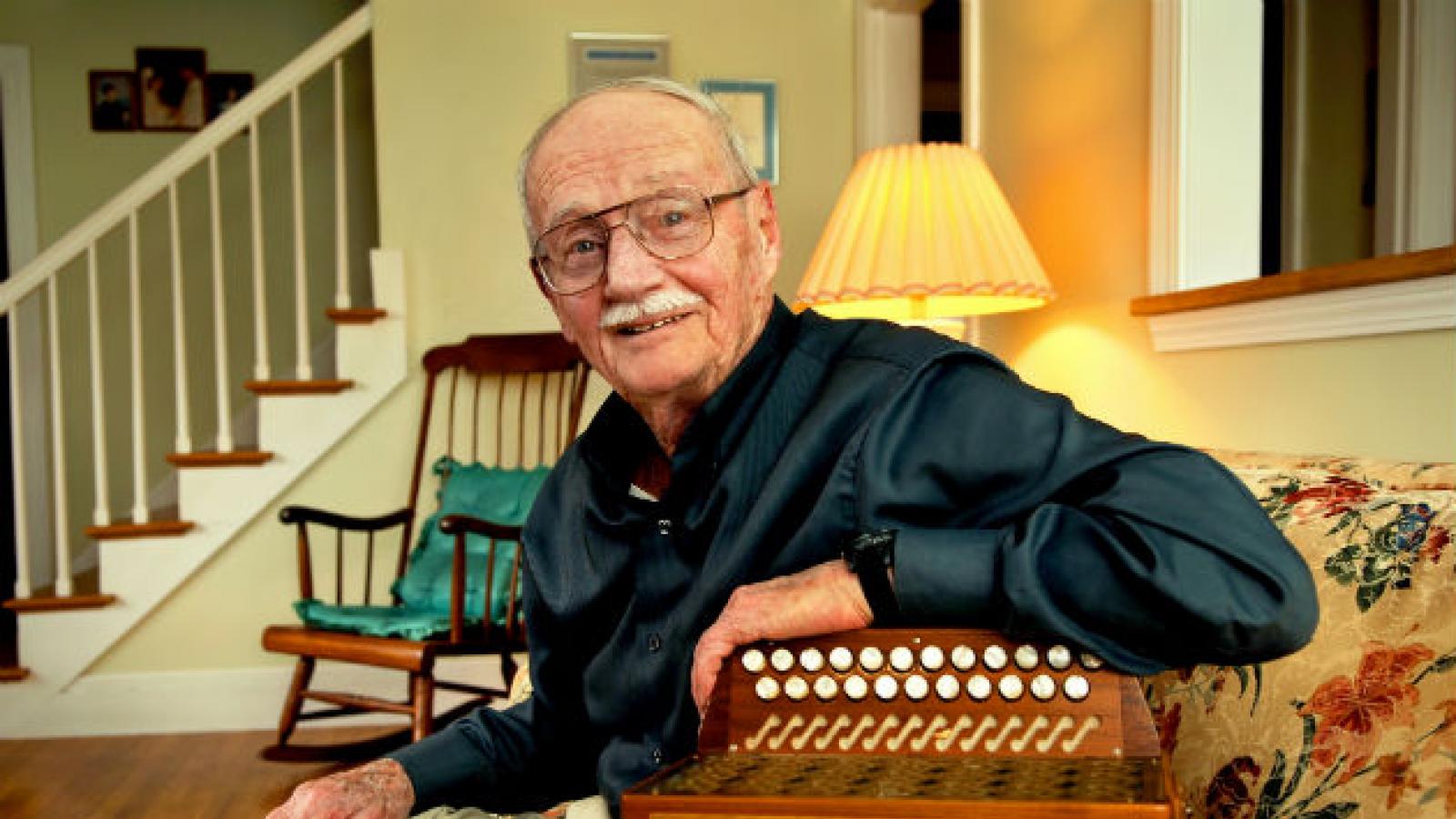 Joe Derrane at home with his accordion