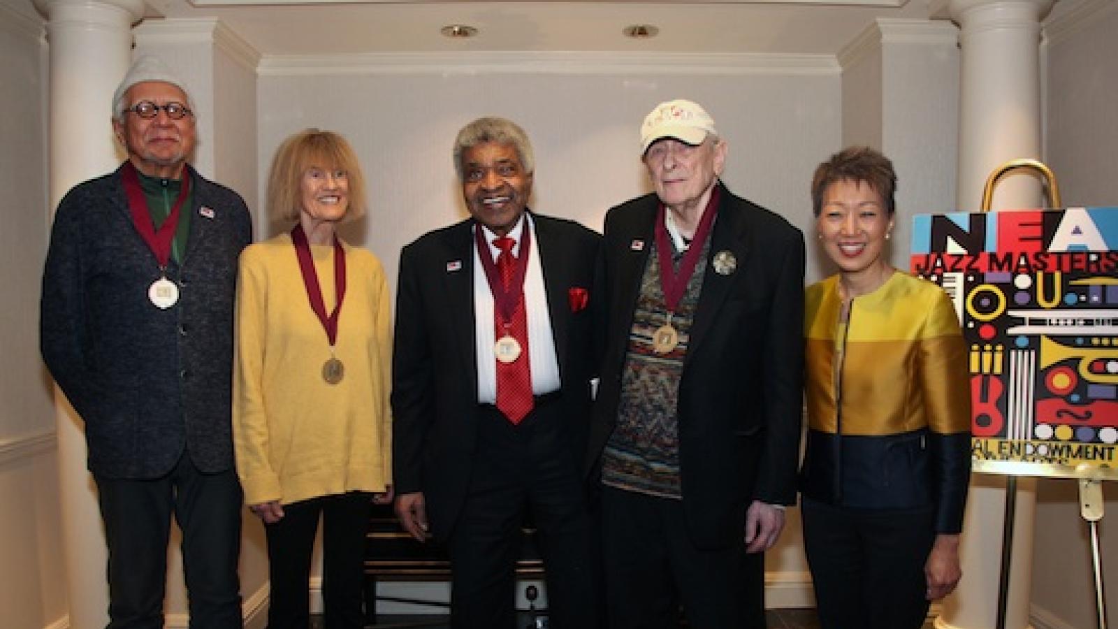 A group shot of NEA Jazz Masters Charles Lloyd, Carla Bley, George Coleman, Joe Segal, and NEA Chair Jane Chu