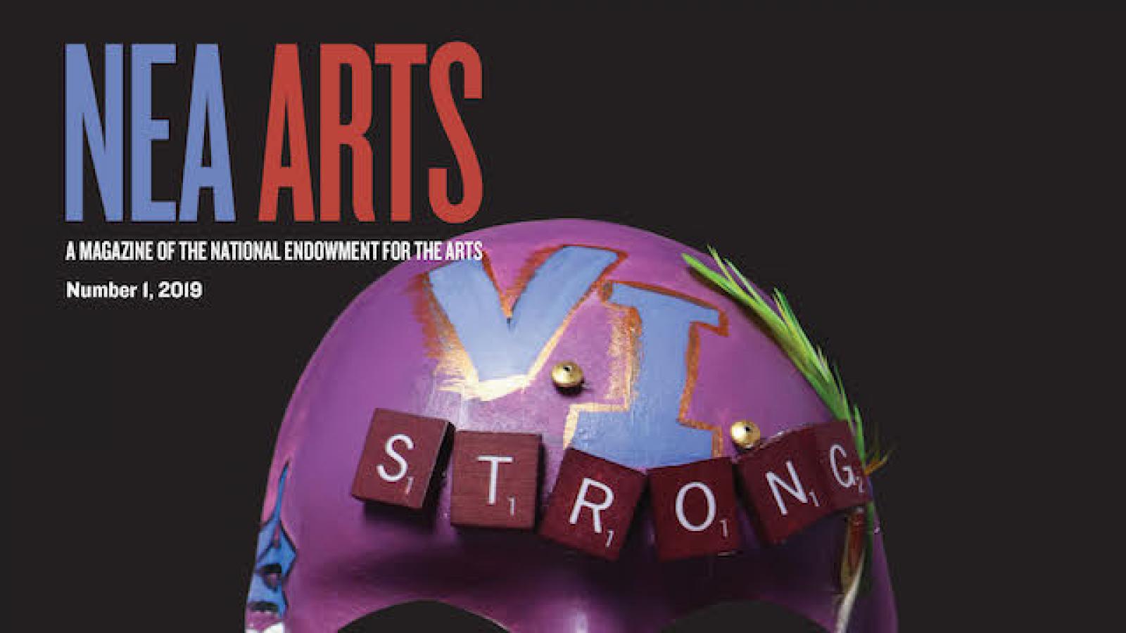 Cover of NEA Arts magazine with a mask on it with the word strong and other embellishment