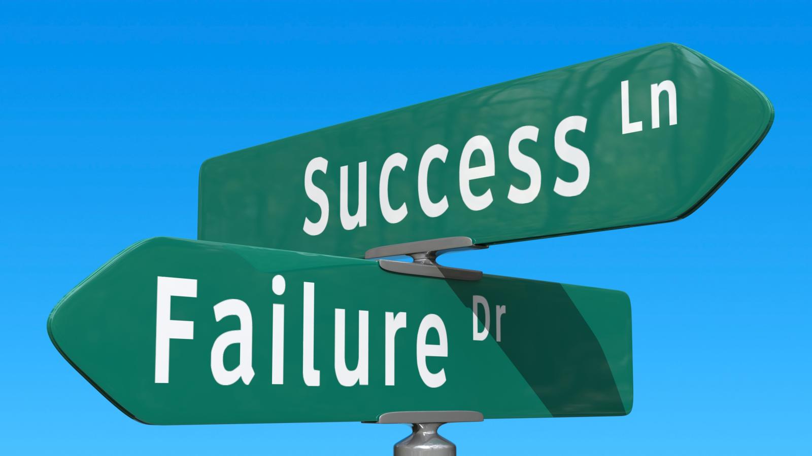 Cross-signs pointing in different directions with one direction saying "success lane" and the other direction "failure drive."
