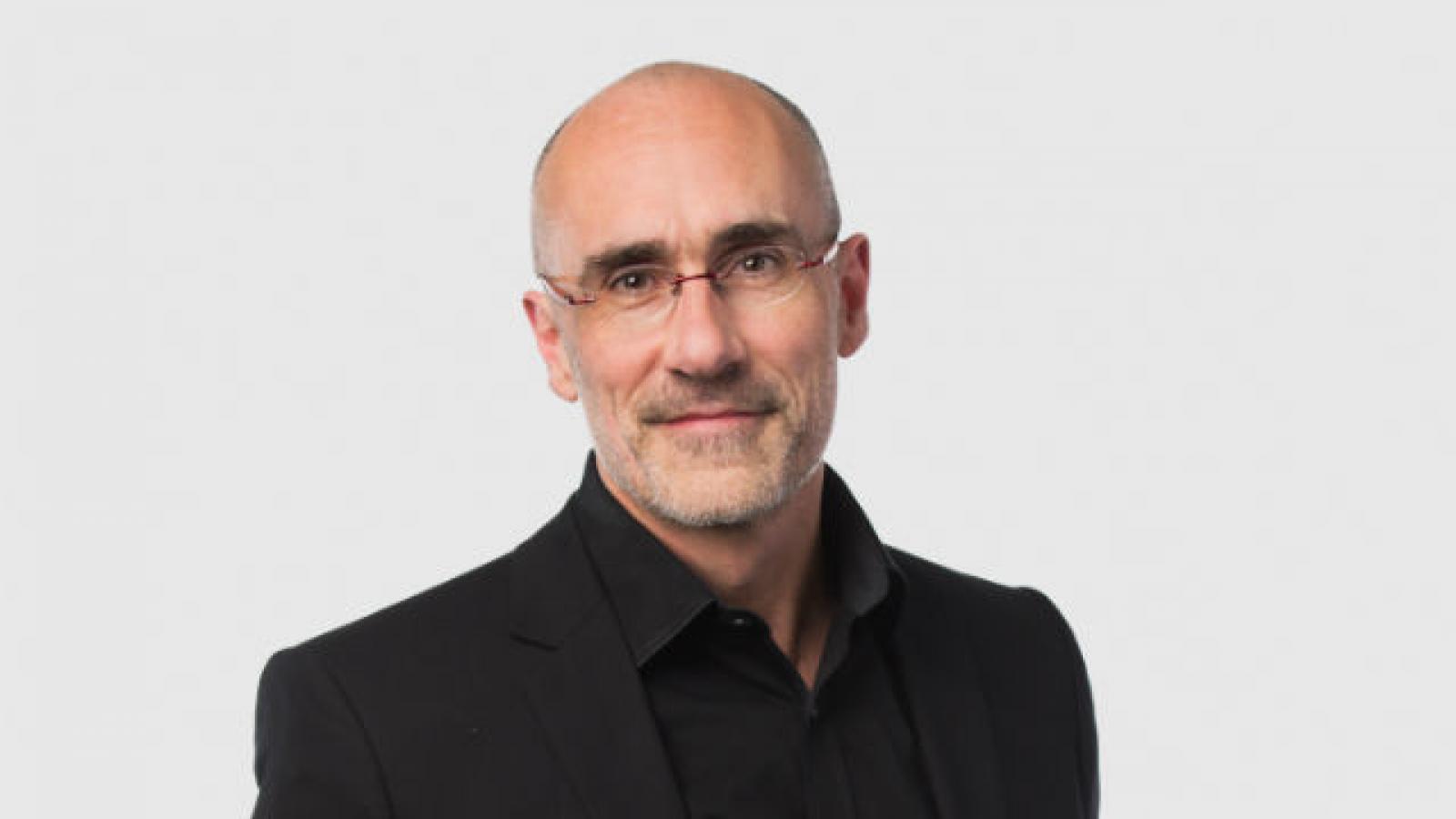 Arthur Brooks Portrait of middle-age man in black suit and glasses