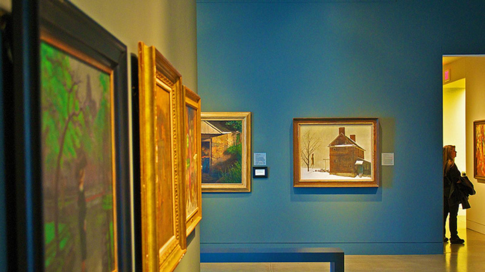 Museum hallway lined with paintings Museum hallway lined with paintings