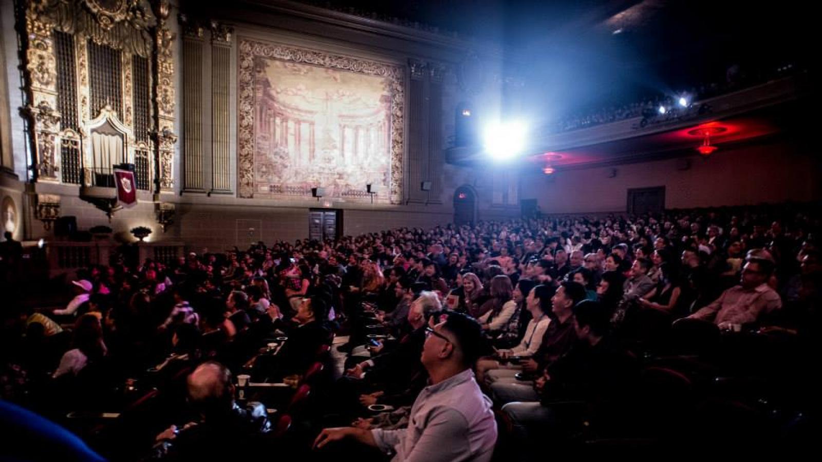 a crowded vintage-looking theater of mostly Asian-American people
