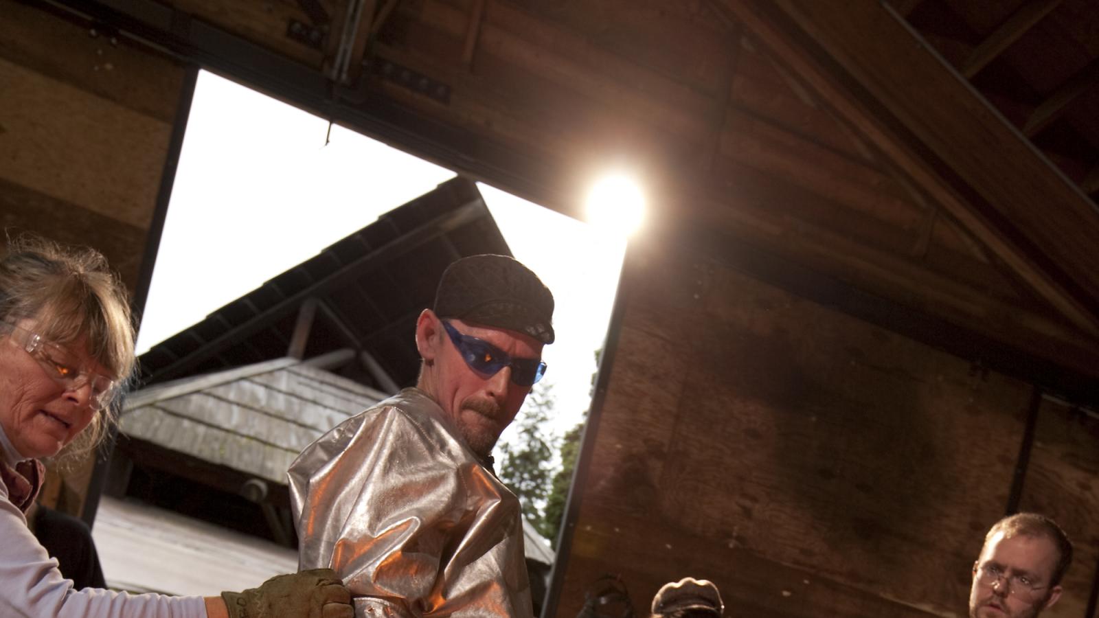 Photo - a woman and man at a glass casting demonstration at the Pilchuck Glass School.