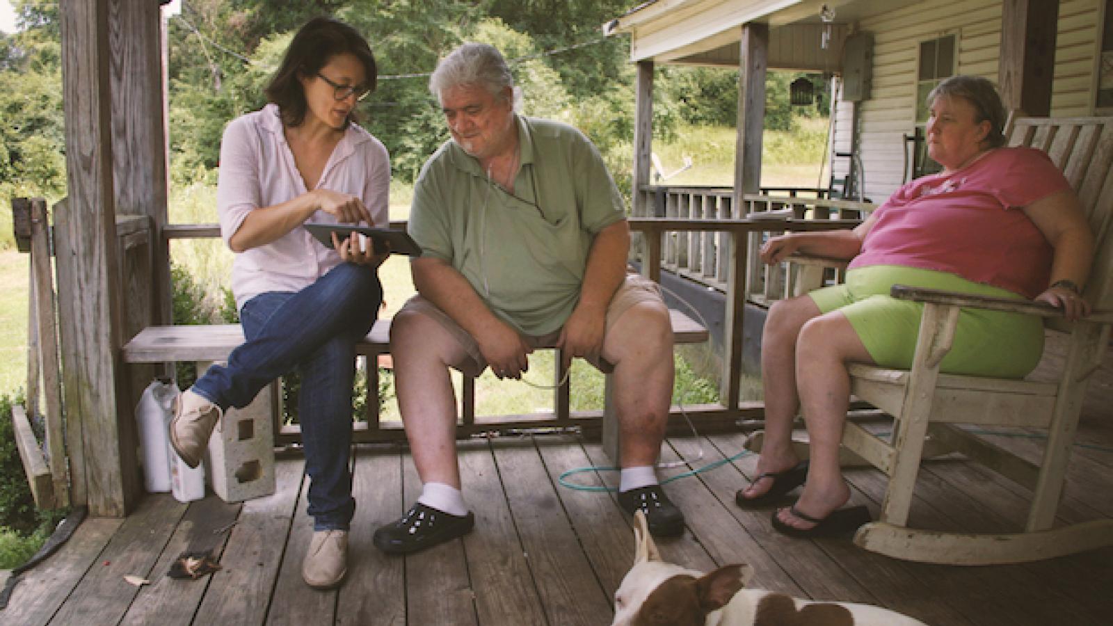 Filmmaker Jennifer Crandall on a porch with two older white people