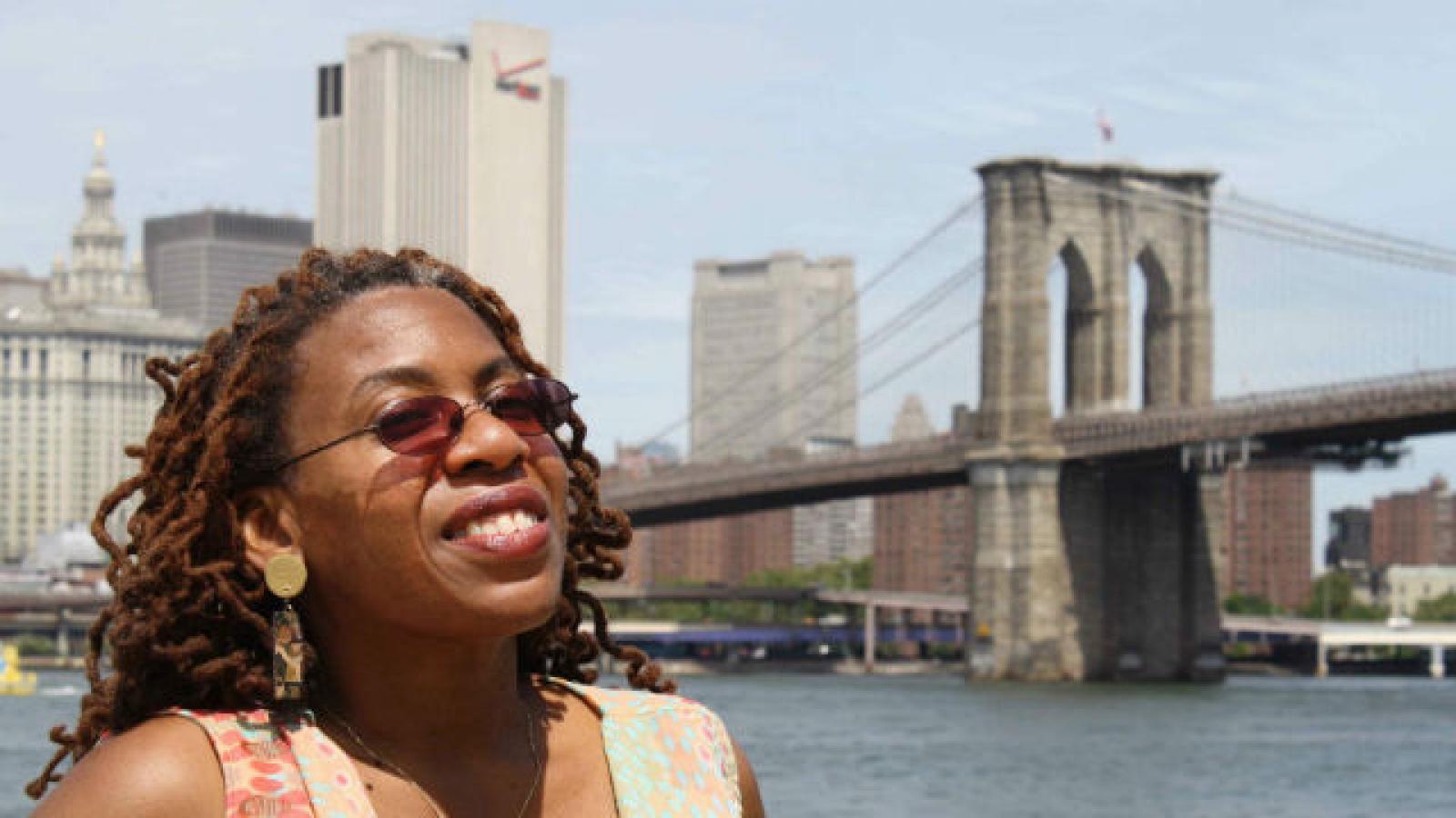 Woman standing in front of Brooklyn Bridge