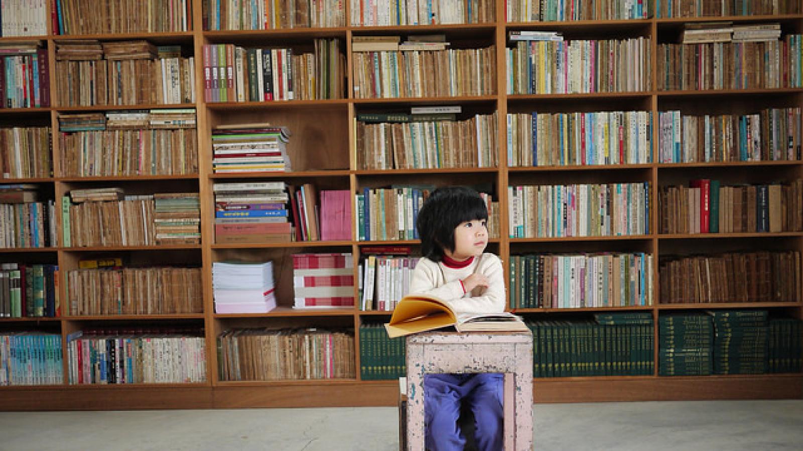 Young boy sitting at table with a book Young boy sitting at table with a book